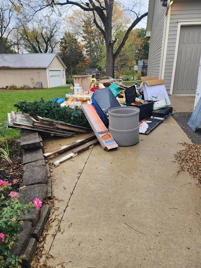 Dumpster being loaded with debris for Roofing Dumpster Rental in Humboldt Hill